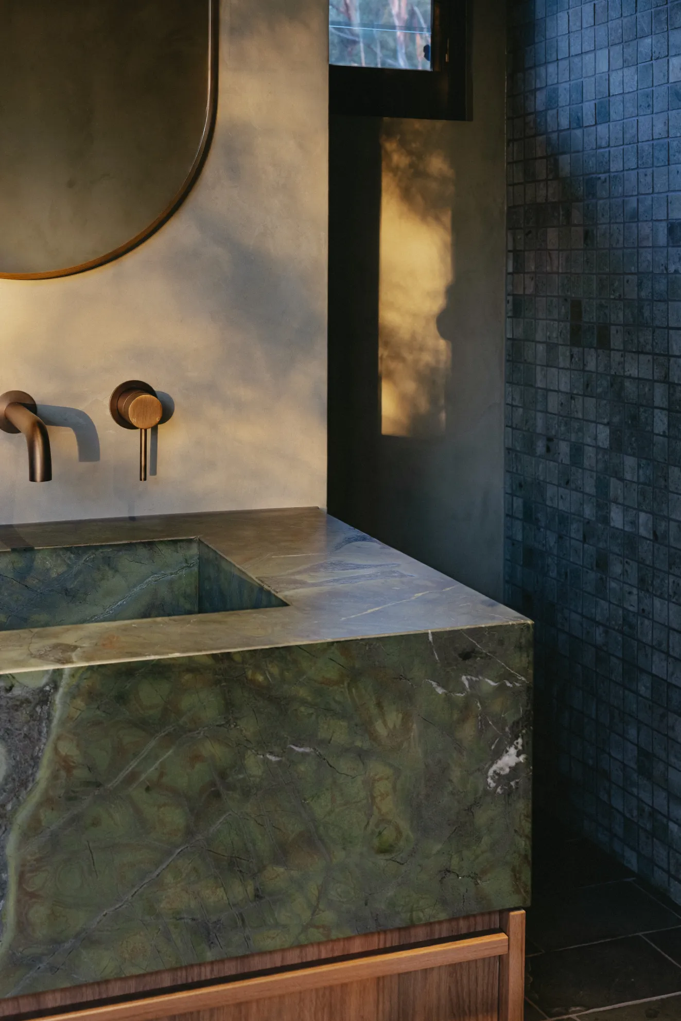 Microcement vanity and feature wall in an Upper Brookfield bathroom, seamless hand-trowelled finish by Dune Artisan Finishes Co.